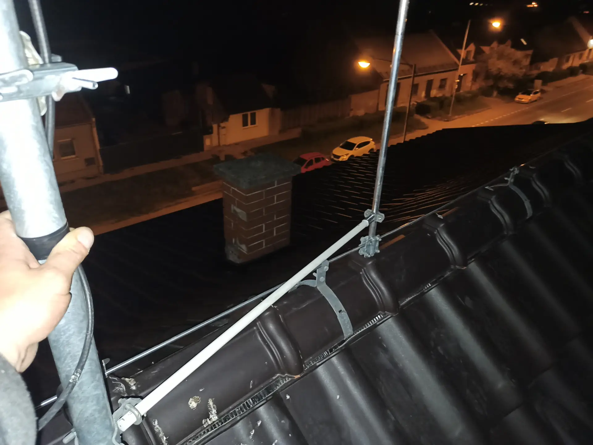 Technický detail hromosvodu na střeše zachycený za nočního osvětlení